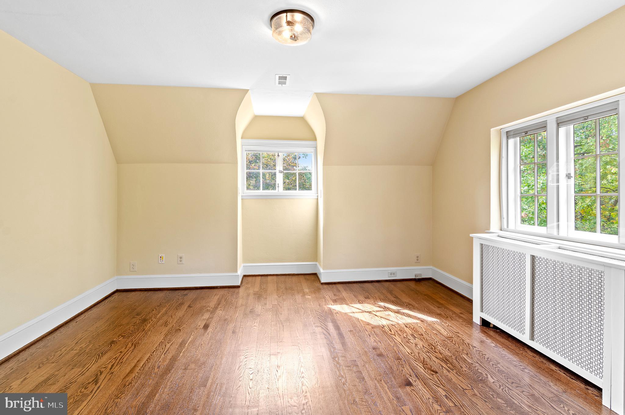7704 Crossland Road Pikesville, MD 21208 - Photo 38 of 68 an empty room with wooden floor and windows