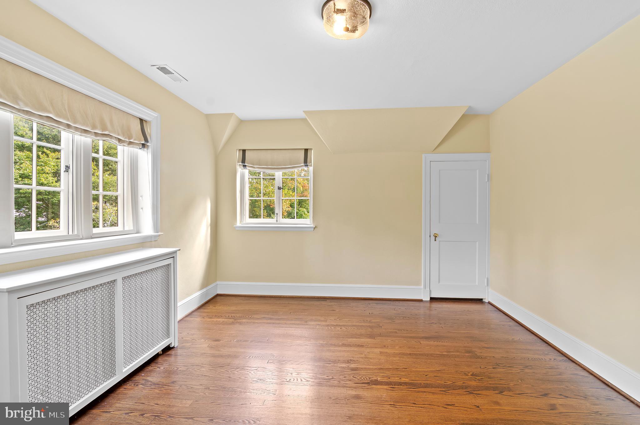 7704 Crossland Road Pikesville, MD 21208 - Photo 39 of 68 an empty room with wooden floor and windows