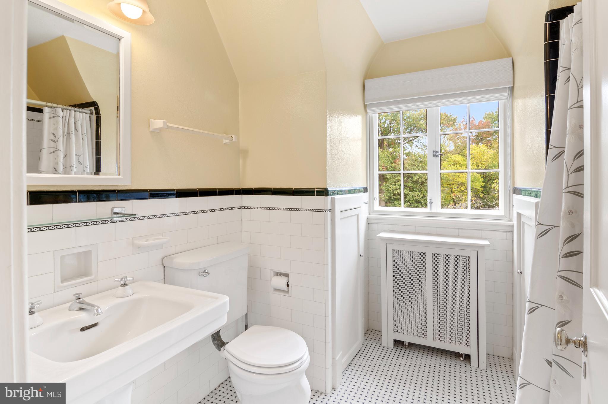 7704 Crossland Road Pikesville, MD 21208 - Photo 41 of 68 a bathroom with a sink a toilet and a mirror