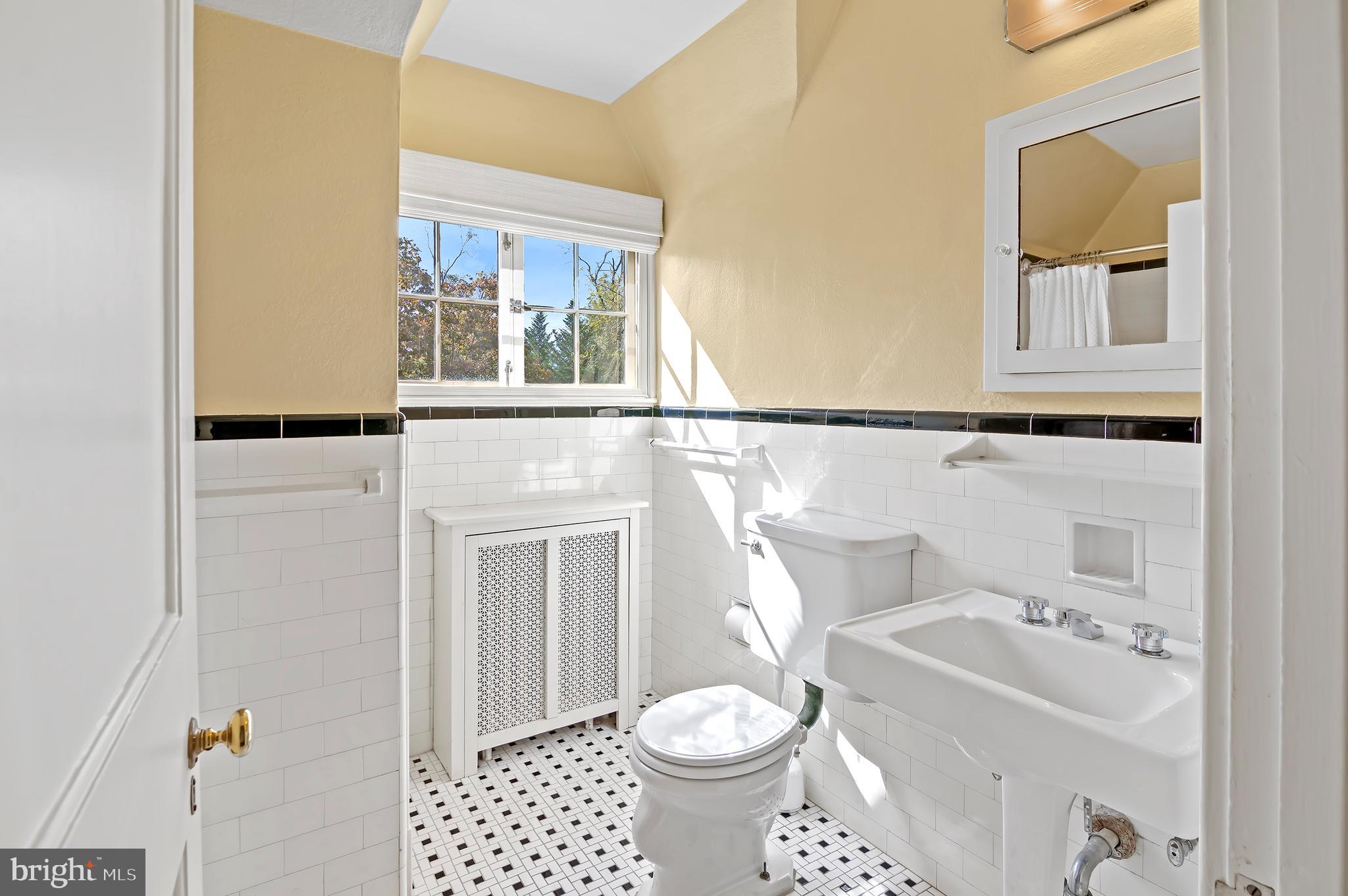 7704 Crossland Road Pikesville, MD 21208 - Photo 42 of 68 a bathroom with a sink toilet and shower