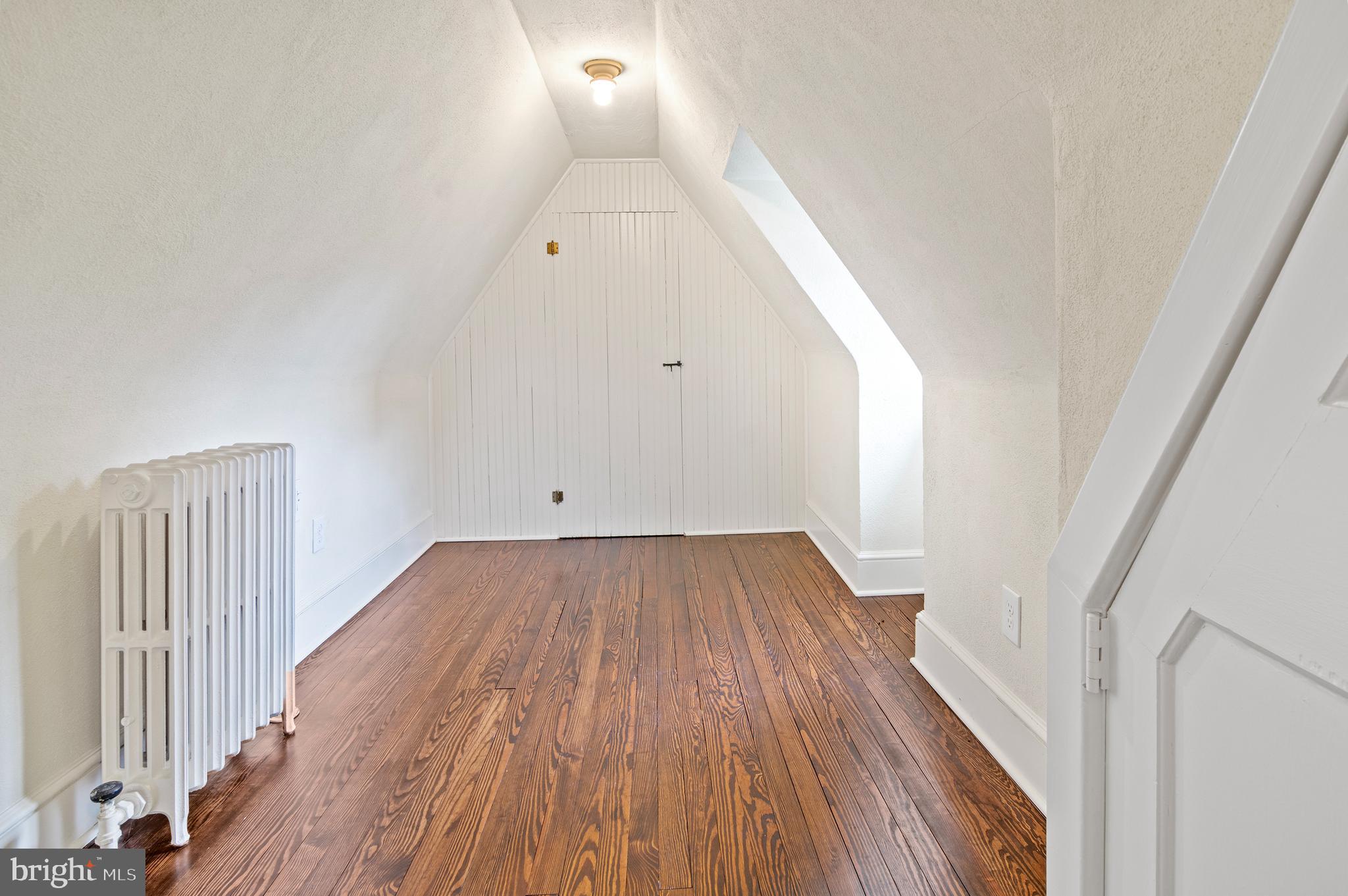 7704 Crossland Road Pikesville, MD 21208 - Photo 46 of 68 a view of a room with wooden floor and white walls