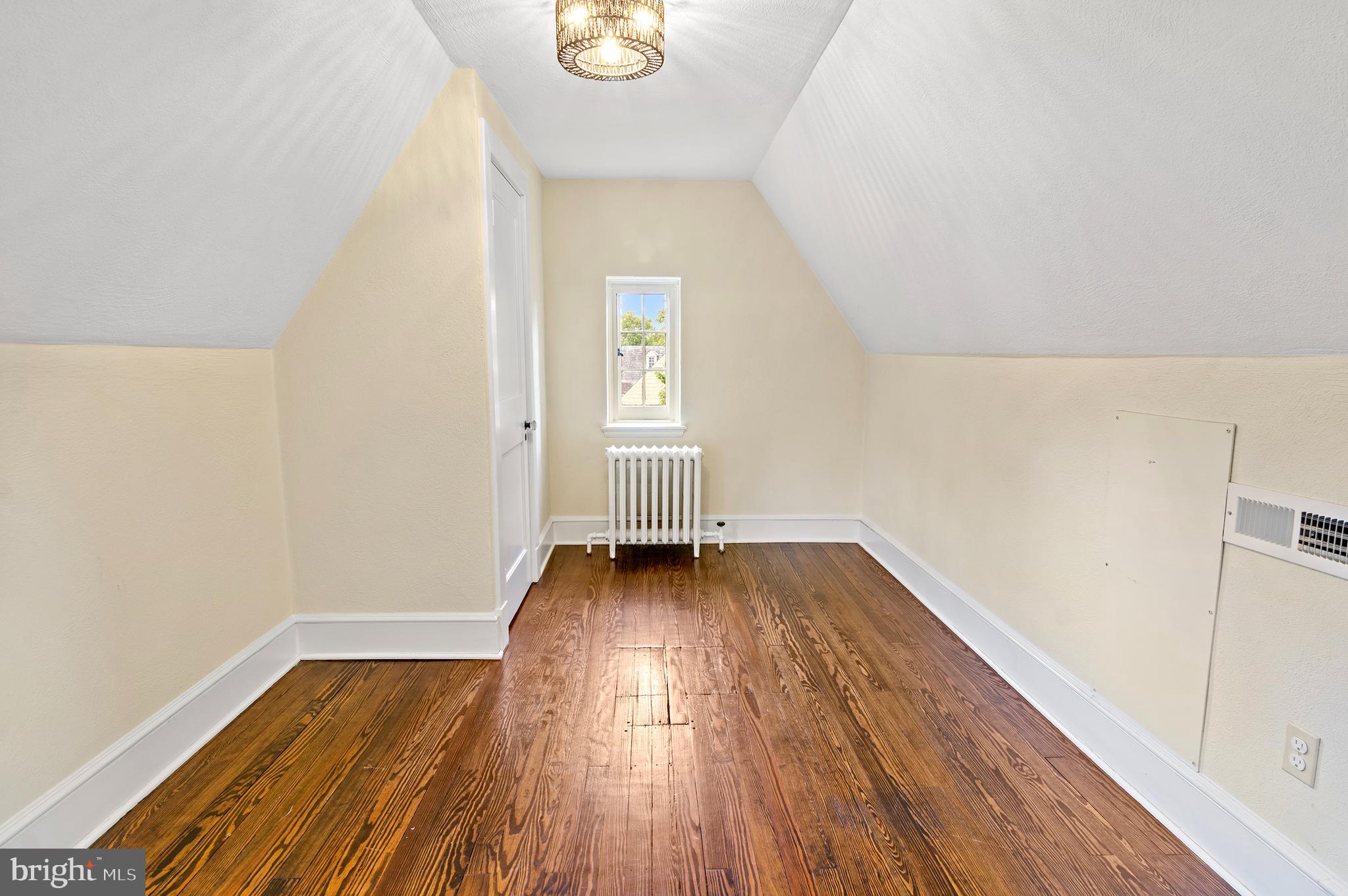 7704 Crossland Road Pikesville, MD 21208 - Photo 47 of 68 a view of a room with wooden floor and window