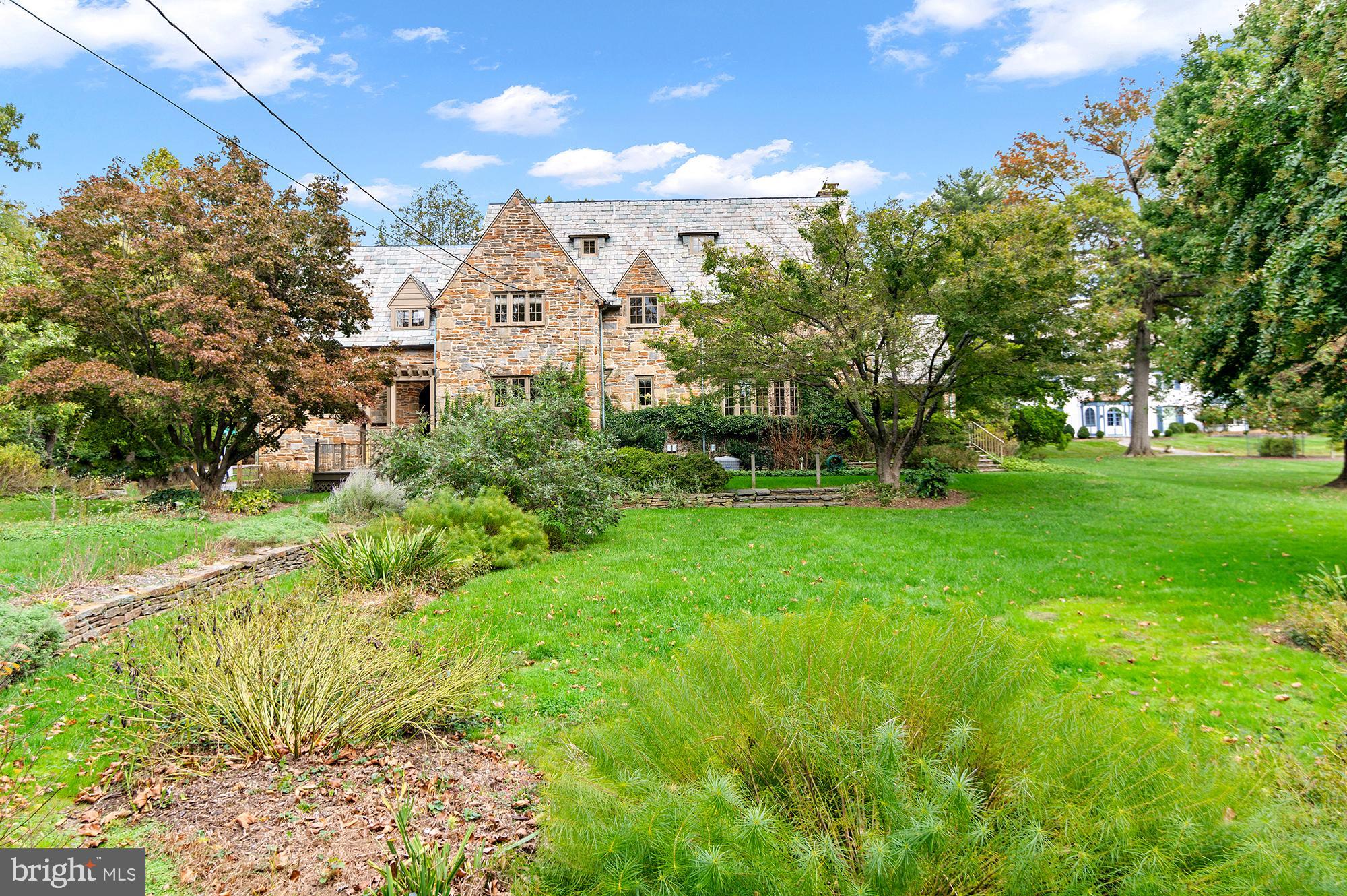 7704 Crossland Road Pikesville, MD 21208 - Photo 59 of 68 a view of a white house with a big yard and large tree