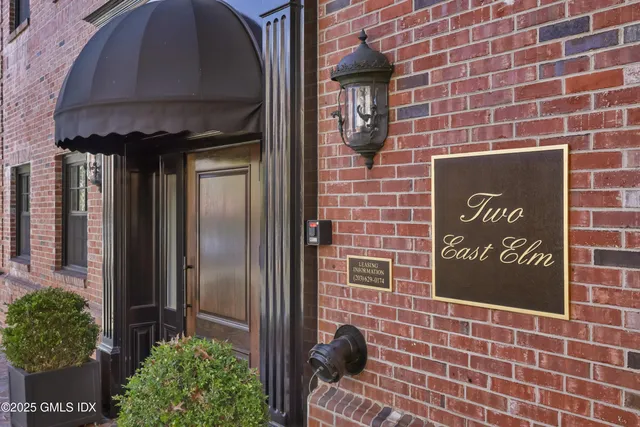 a brick building with a sign on it