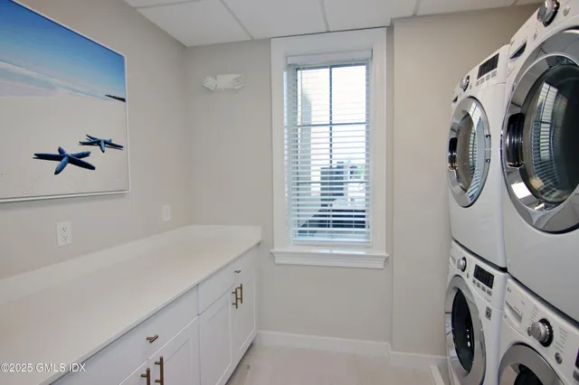 a utility room with multiple dryer and washer