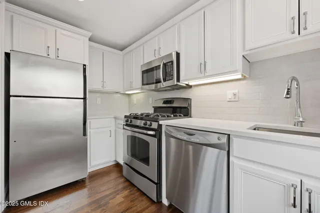 a utility room with multiple dryer and washer