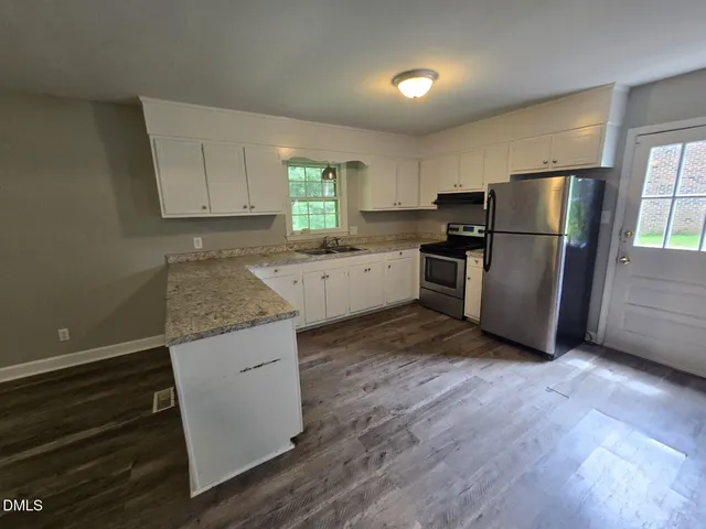 a kitchen with a refrigerator sink and stove