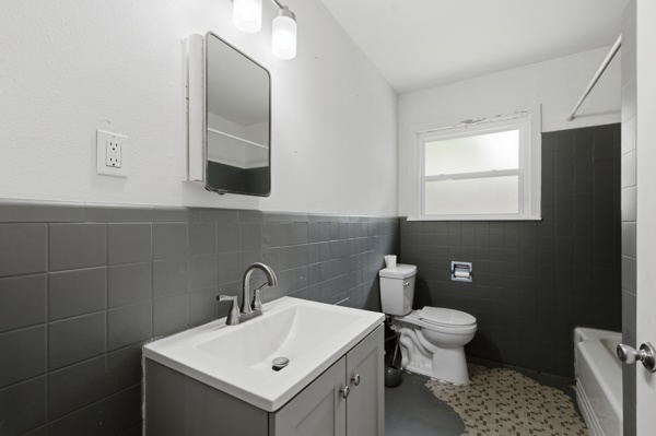 1608 Burt Street Bryan, TX 77802 - Photo 12 of 16 a bathroom with a sink toilet and mirror