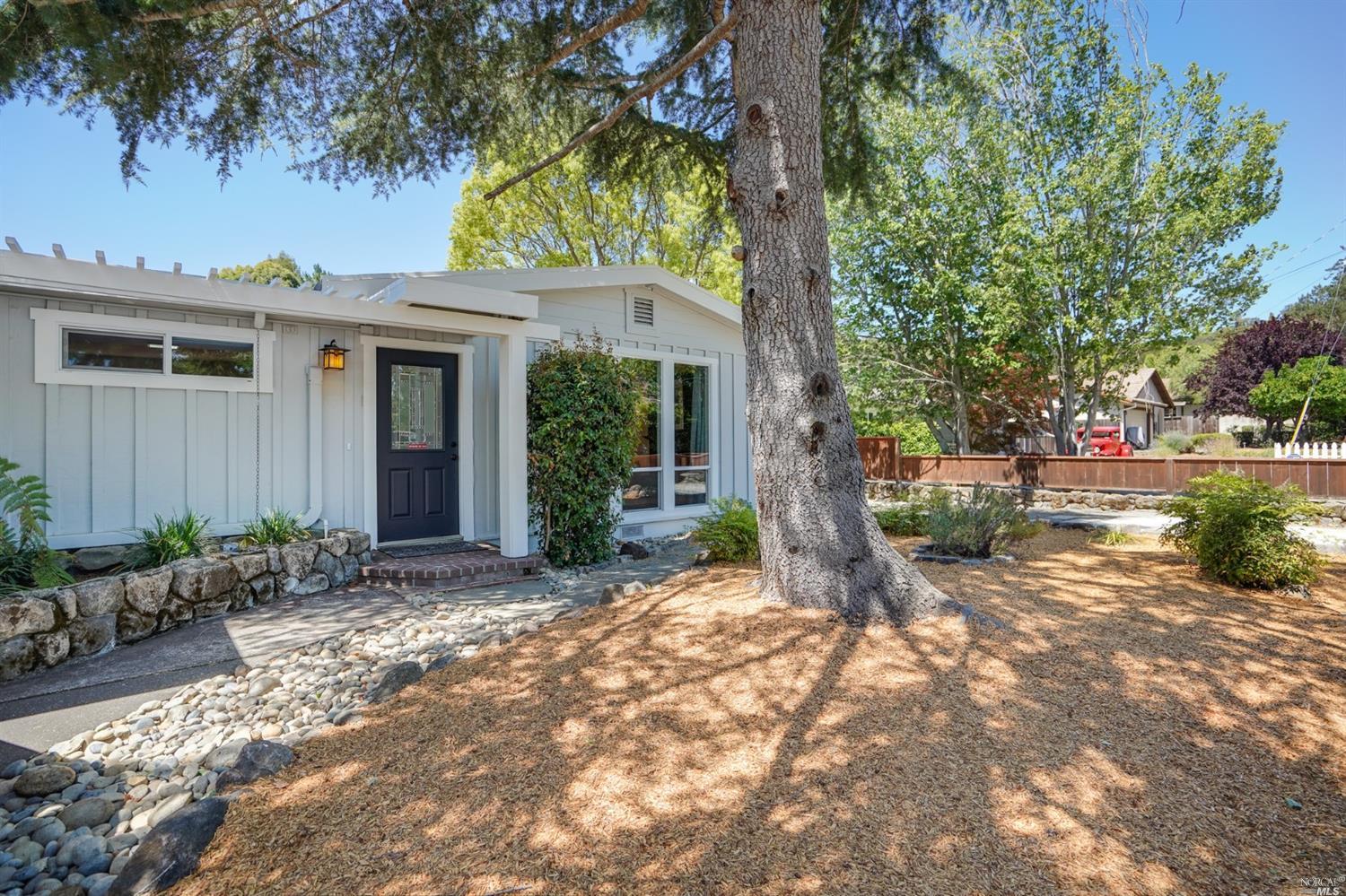 a view of a house with a tree in a yard