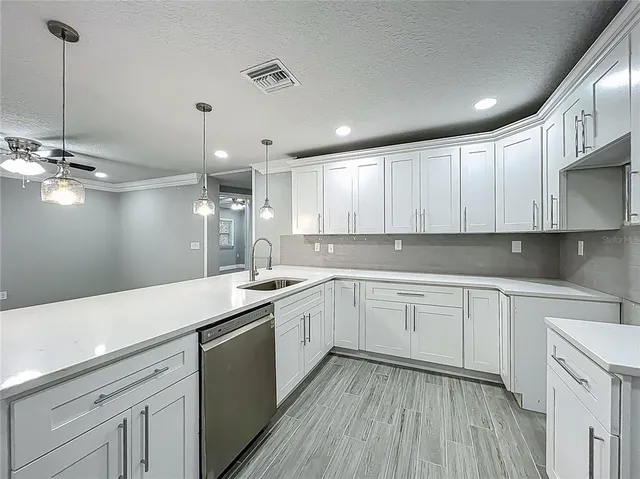 a kitchen with a hard wood floor and white appliances