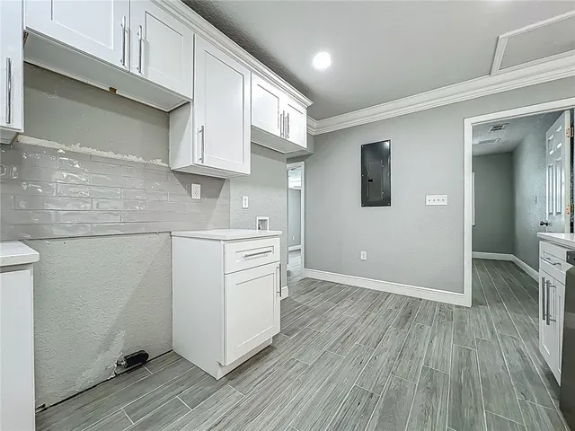 a kitchen with kitchen island a sink stainless steel appliances and chandelier
