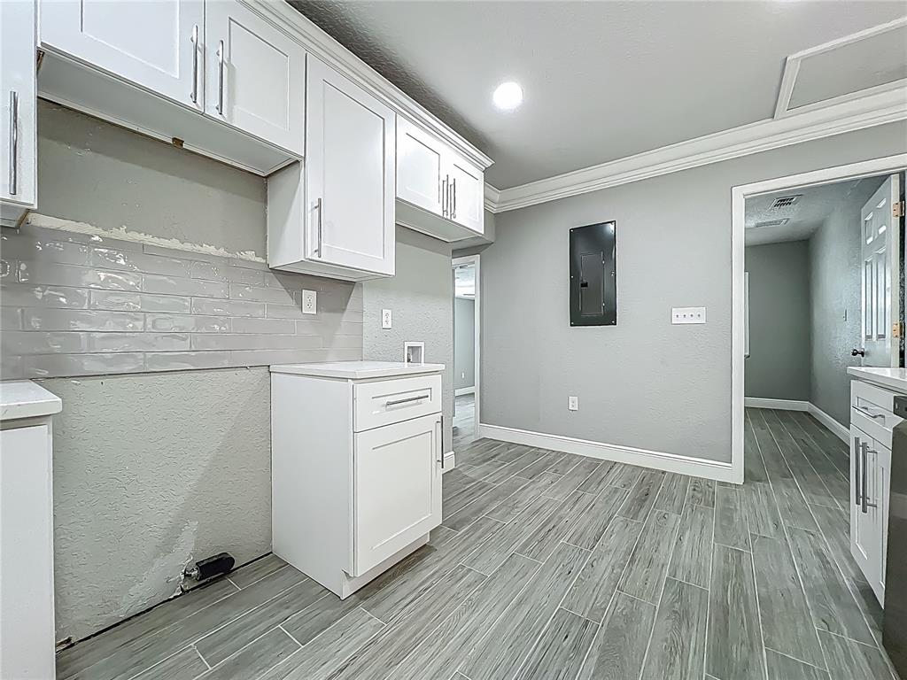 1414 Beaver Street Orlando, FL 32806 - Photo 14 of 43 a kitchen with a hard wood floor and white appliances