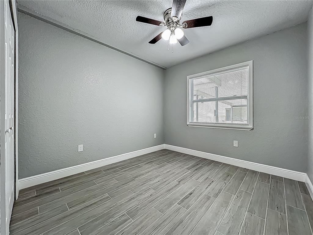 1414 Beaver Street Orlando, FL 32806 - Photo 16 of 43 a view of empty room with wooden floor and fan