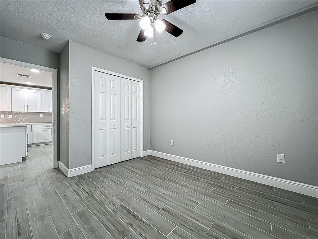 1414 Beaver Street Orlando, FL 32806 - Photo 17 of 43 a view of an empty room with a window and wooden floor