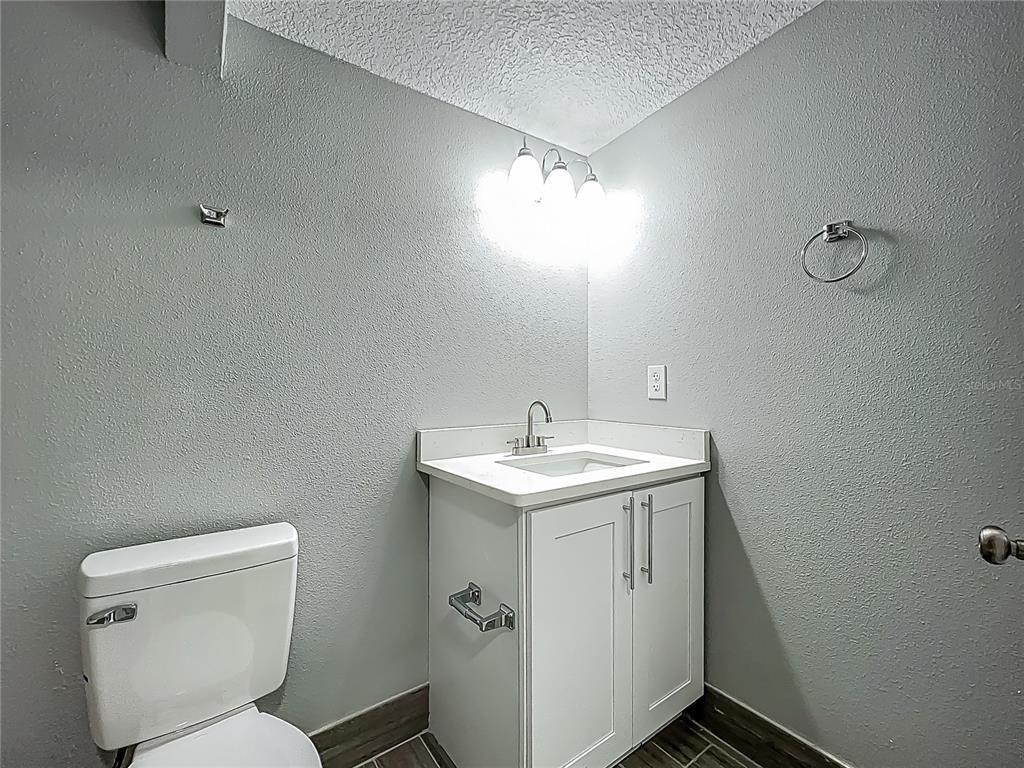 1414 Beaver Street Orlando, FL 32806 - Photo 21 of 43 a bathroom with a toilet sink and mirror