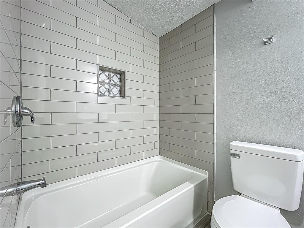 1414 Beaver Street Orlando, FL 32806 - Photo 22 of 43 a bathroom with a toilet and bathtub