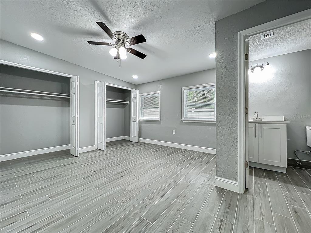 1414 Beaver Street Orlando, FL 32806 - Photo 23 of 43 a view of an empty room with wooden floor and a ceiling fan