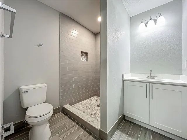 a view of a room with wooden floor and small window