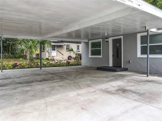 an empty room with windows and a fireplace