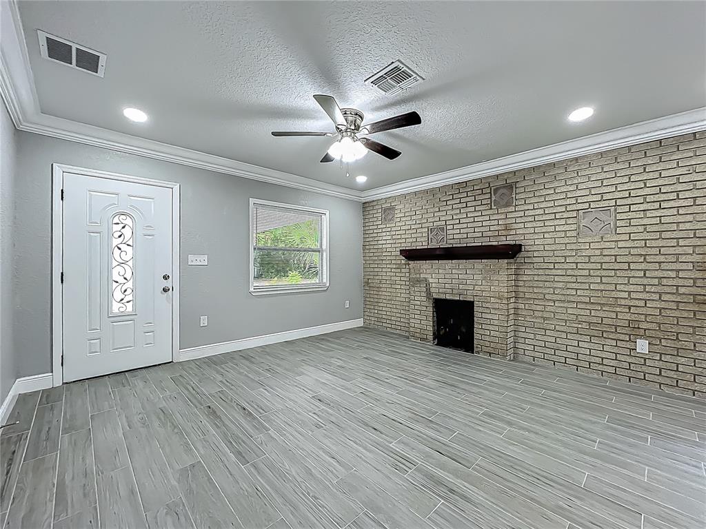 1414 Beaver Street Orlando, FL 32806 - Photo 5 of 43 an empty room with windows and a fireplace
