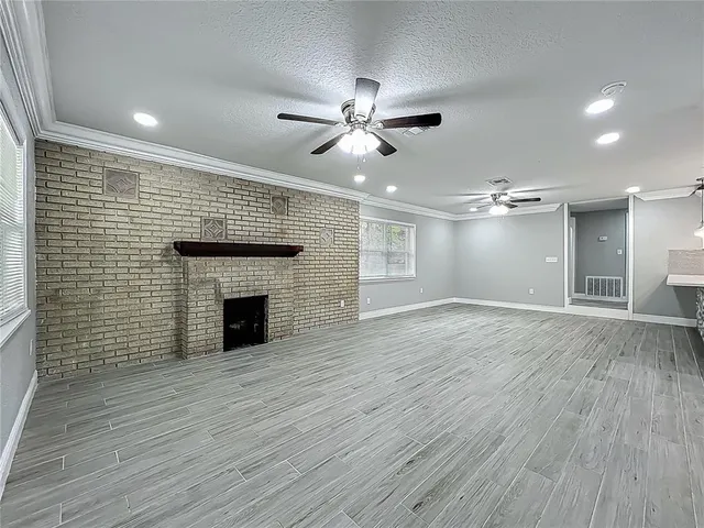 a room with wooden floors and natural light