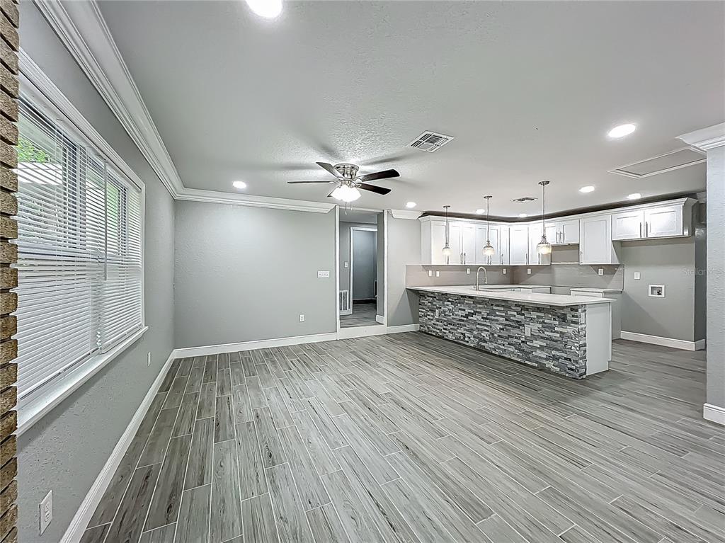 1414 Beaver Street Orlando, FL 32806 - Photo 7 of 43 a room with wooden floors and natural light