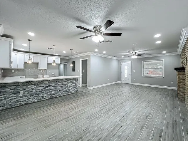 a large kitchen with kitchen island a sink stainless steel appliances and cabinets