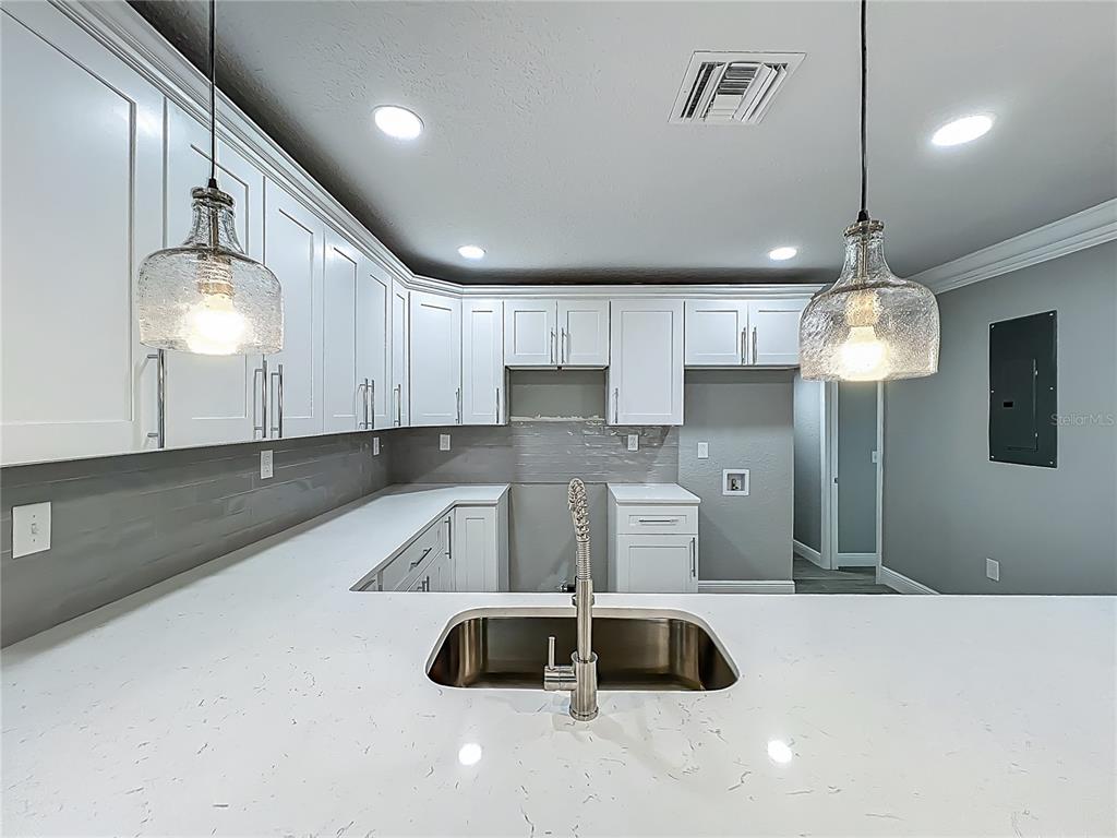 1414 Beaver Street Orlando, FL 32806 - Photo 10 of 43 a kitchen with granite countertop a stove a sink and a refrigerator