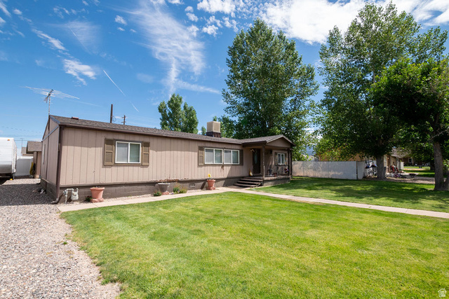 855 East 300 N Street Beaver, UT 84713 - Photo 3 of 44 Single-story residence featuring a covered front porch entry, light-colored siding, and a shingled roof