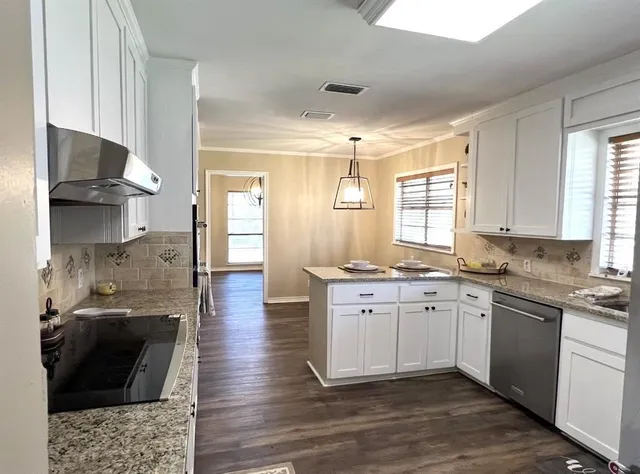 a spacious bathroom with a granite countertop sink a mirror and a shower