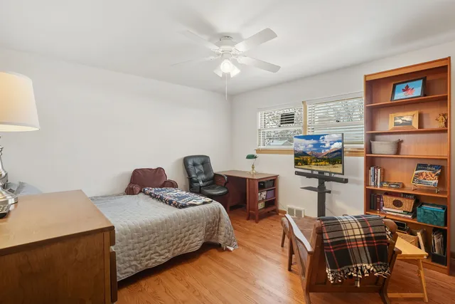 a bedroom with furniture and a chandelier