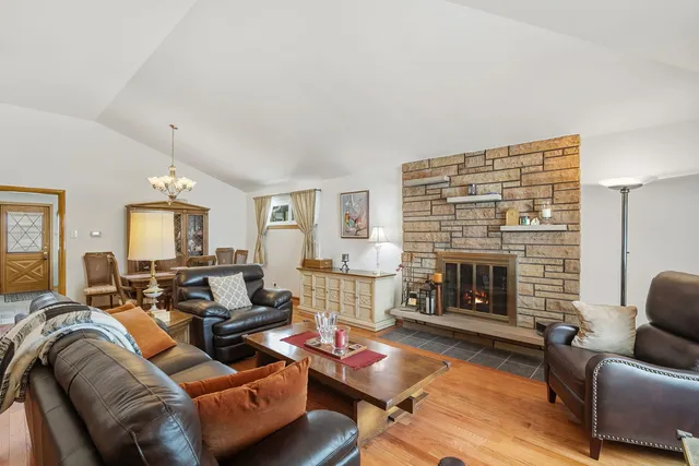 a living room with furniture fireplace and a table