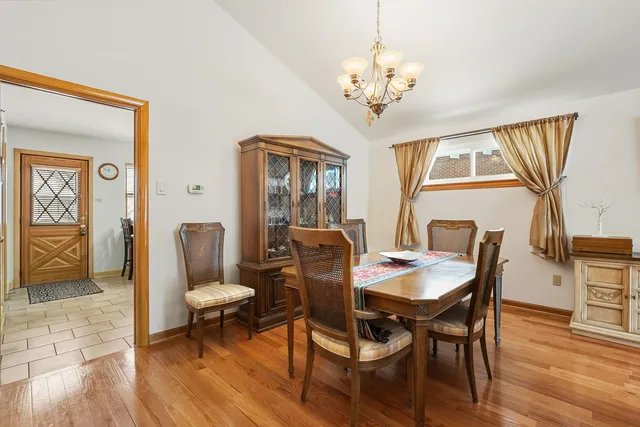 a view of a dining room with furniture wooden floor and a chandelier
