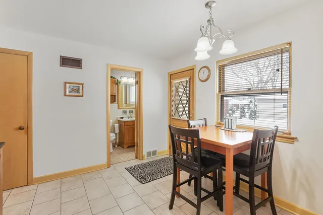a view of a dining room with furniture and window