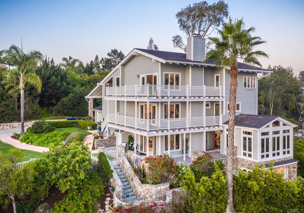 a front view of a house with a yard garage and outdoor seating