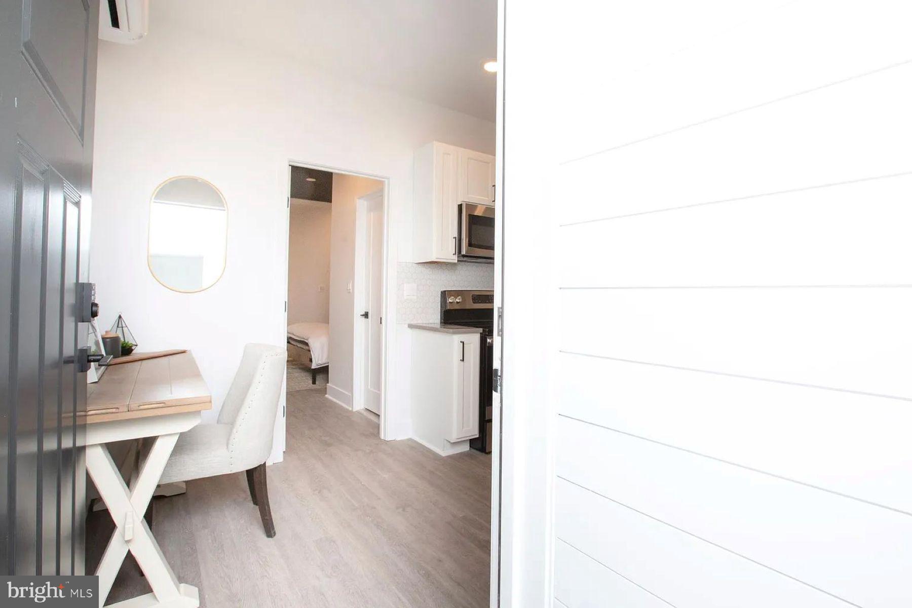 1742 Fleet Street, Unit 301 Baltimore, MD 21231 - Photo 4 of 20 a workspace with furniture and wooden floor