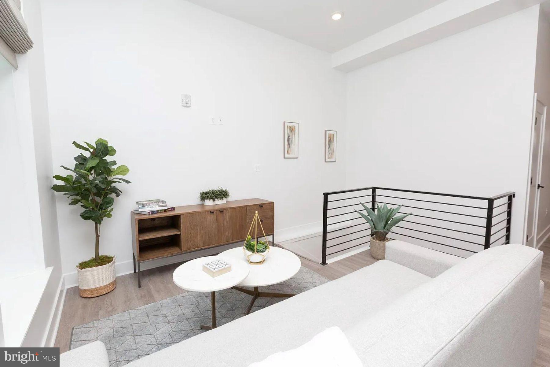 1742 Fleet Street, Unit 301 Baltimore, MD 21231 - Photo 6 of 20 a living room with furniture potted plant and a window