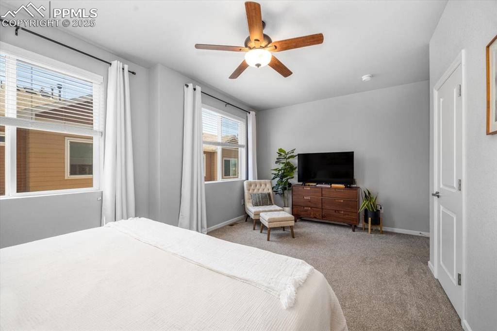 15446 West 64th Loop, Unit D Arvada, CO 80007 - Photo 11 of 22 a bedroom with a bed and a flat screen tv