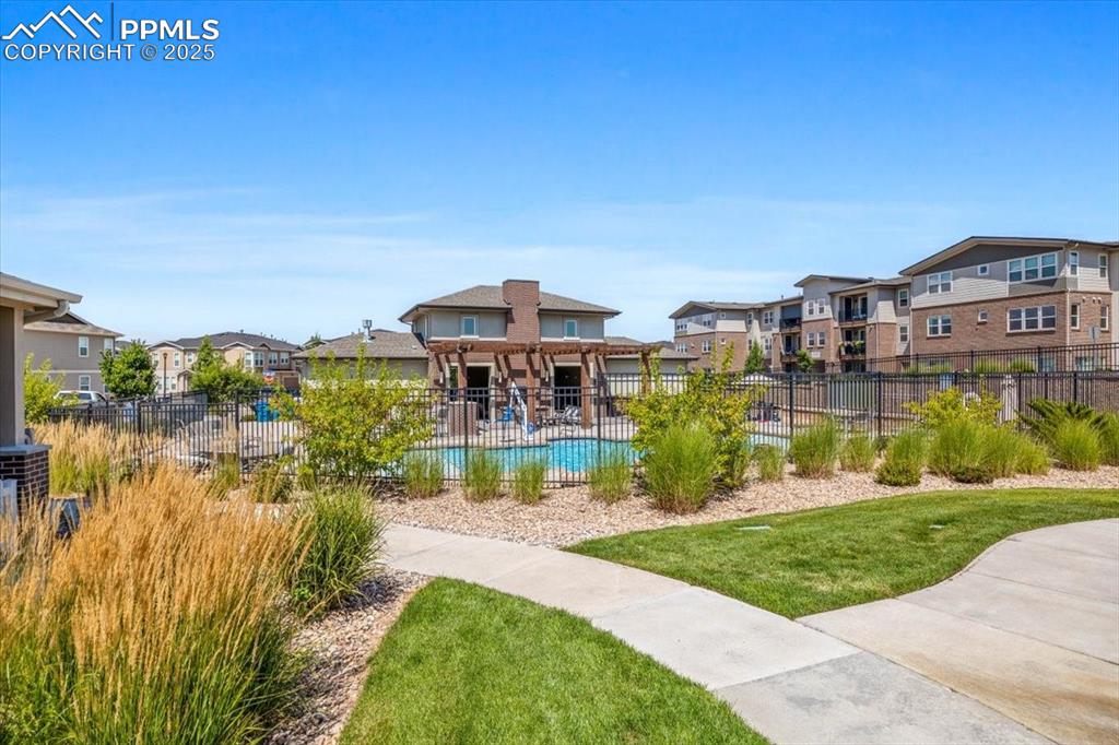 15446 West 64th Loop, Unit D Arvada, CO 80007 - Photo 20 of 22 a view of a big building in front of a big yard with large trees