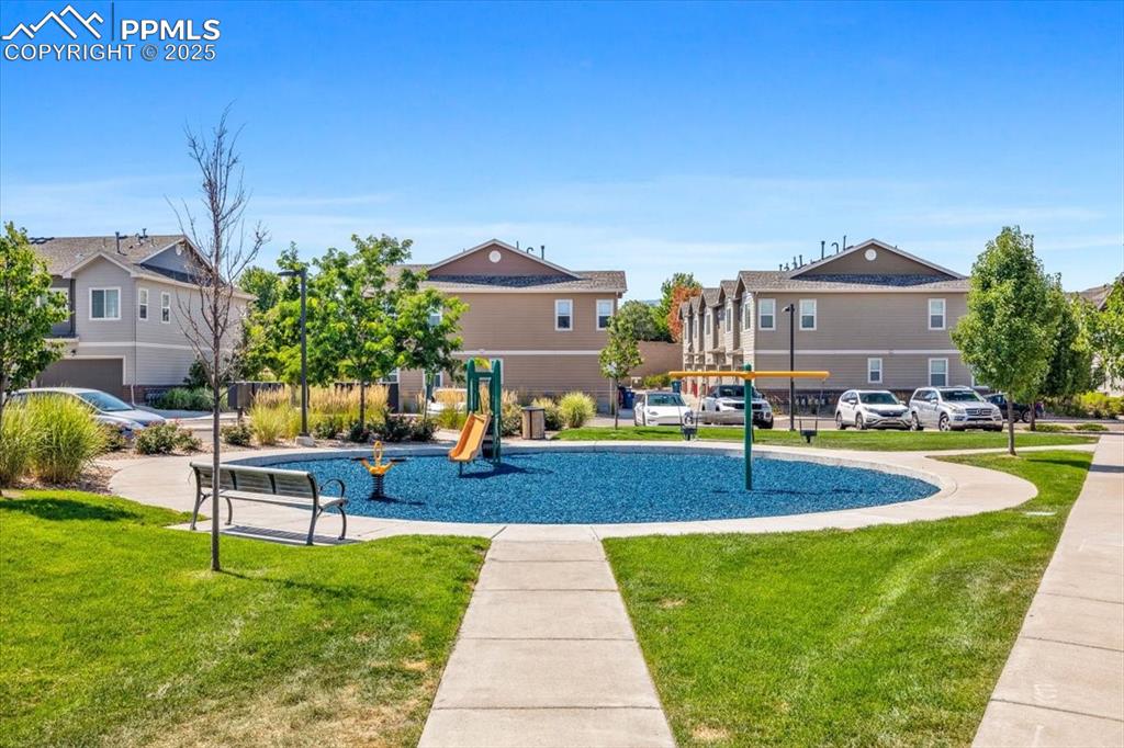 15446 West 64th Loop, Unit D Arvada, CO 80007 - Photo 21 of 22 a front view of a house with a yard