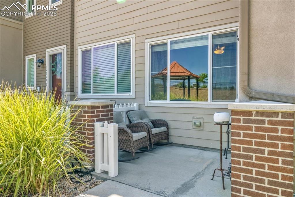 15446 West 64th Loop, Unit D Arvada, CO 80007 - Photo 3 of 22 front view of a house with a porch