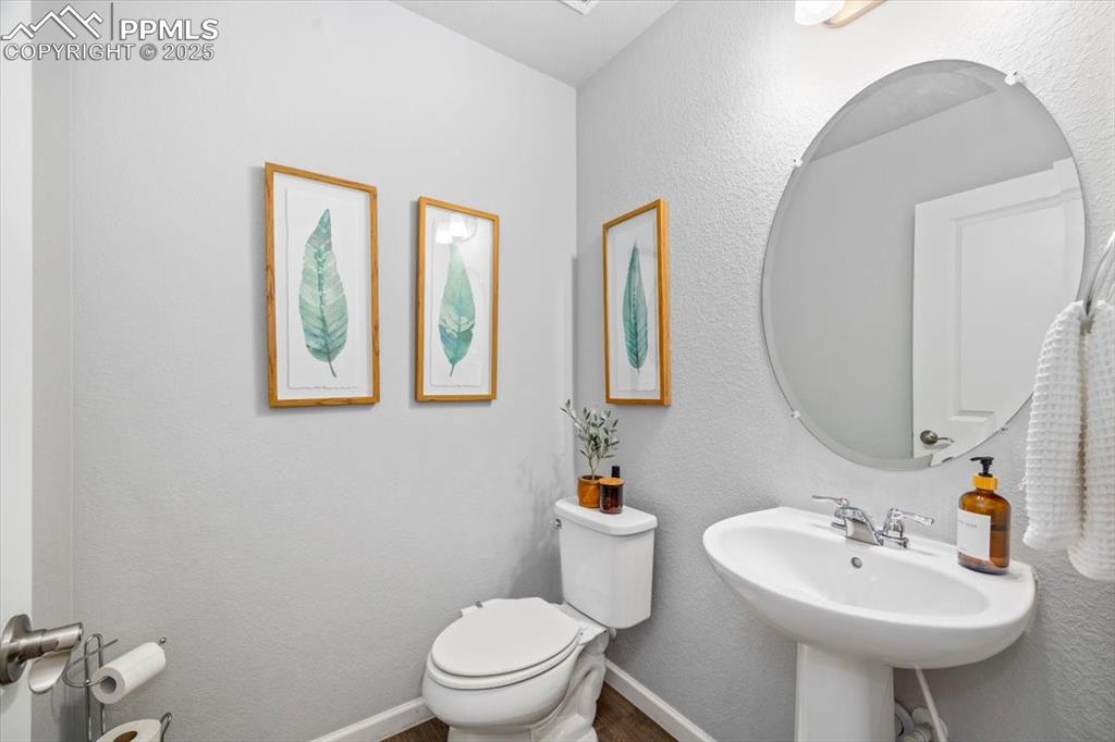 15446 West 64th Loop, Unit D Arvada, CO 80007 - Photo 9 of 22 a bathroom with a toilet sink and mirror