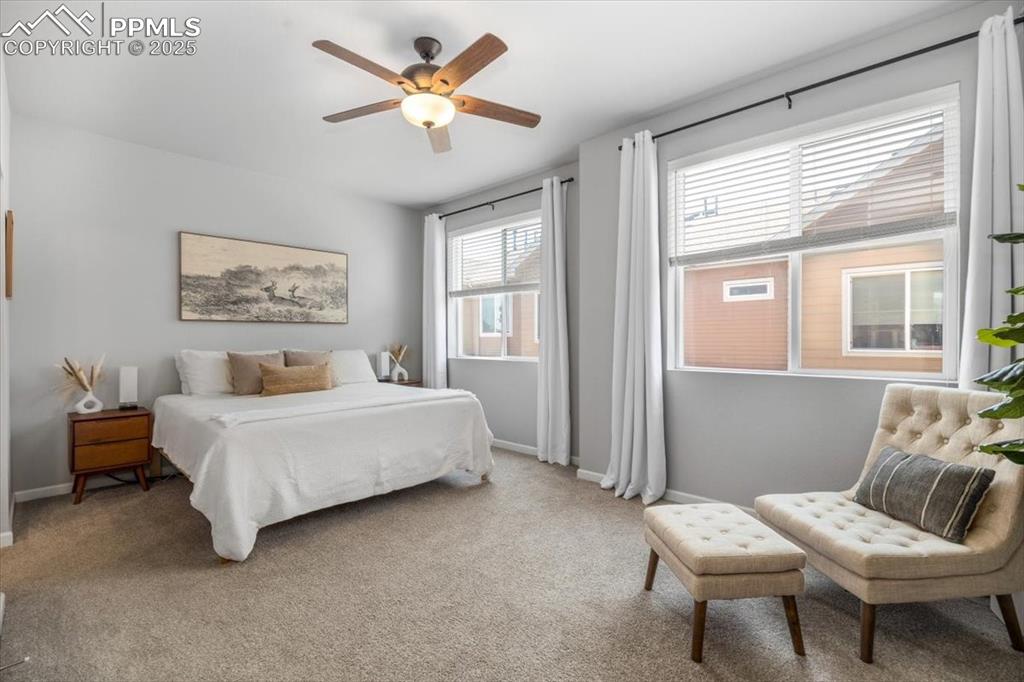 15446 West 64th Loop, Unit D Arvada, CO 80007 - Photo 10 of 22 a spacious bedroom with a bed and a chair