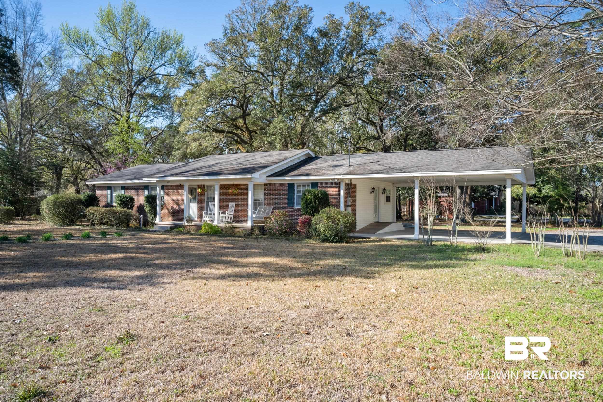 809 Moog Avenue Bay Minette, AL 36507 - Photo 2 of 33 Ranch-style house with covered porch, a carport, a front lawn, and brick siding
