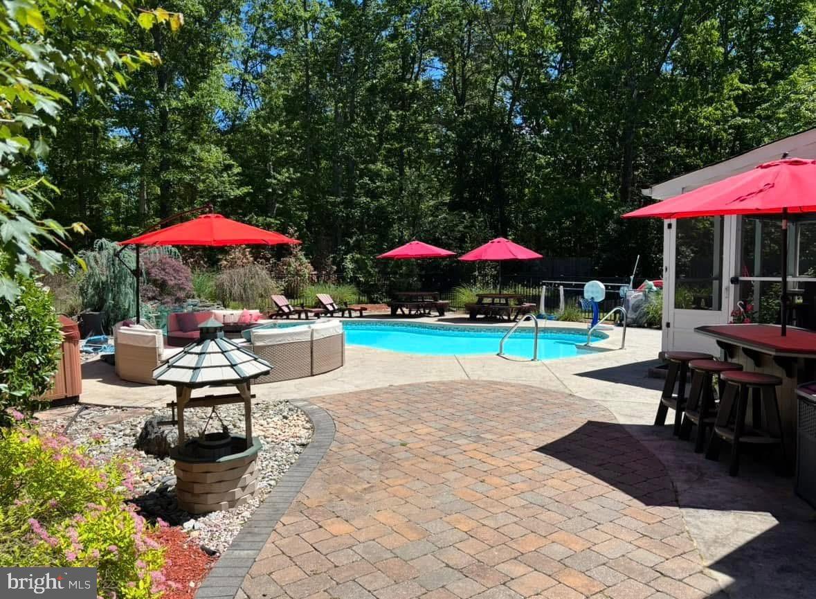10 Cutts Drive Tabernacle, NJ 08088 - Photo 8 of 62 a view of a patio with a table and chairs under an umbrella