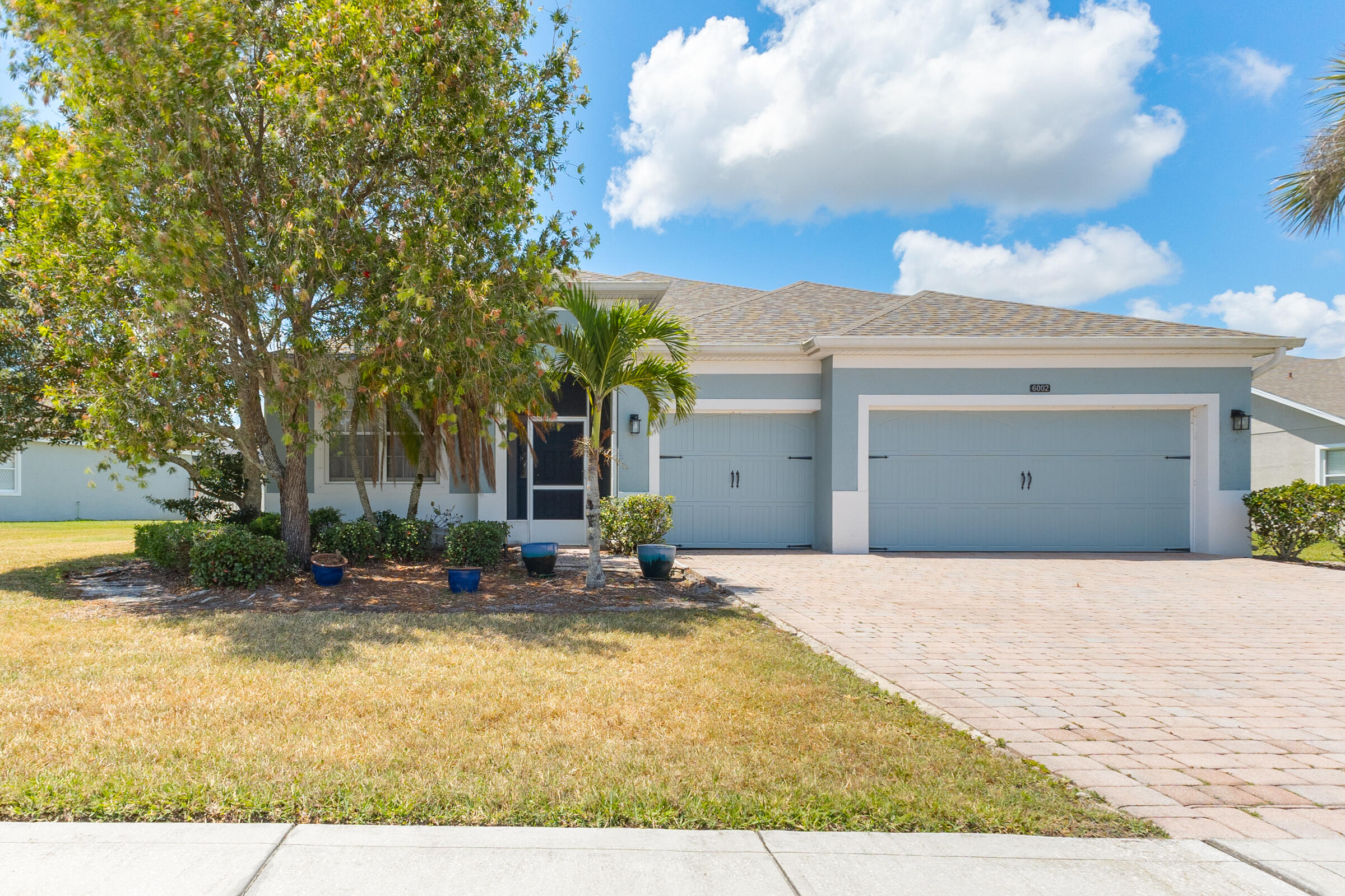 a view of the house with swimming pool and sitting area