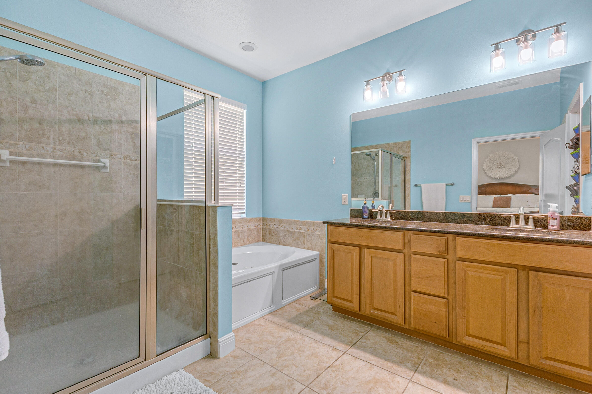 6002 Goleta Circle Melbourne, FL 32940 - Photo 16 of 45 a bathroom with a tub sink and mirror