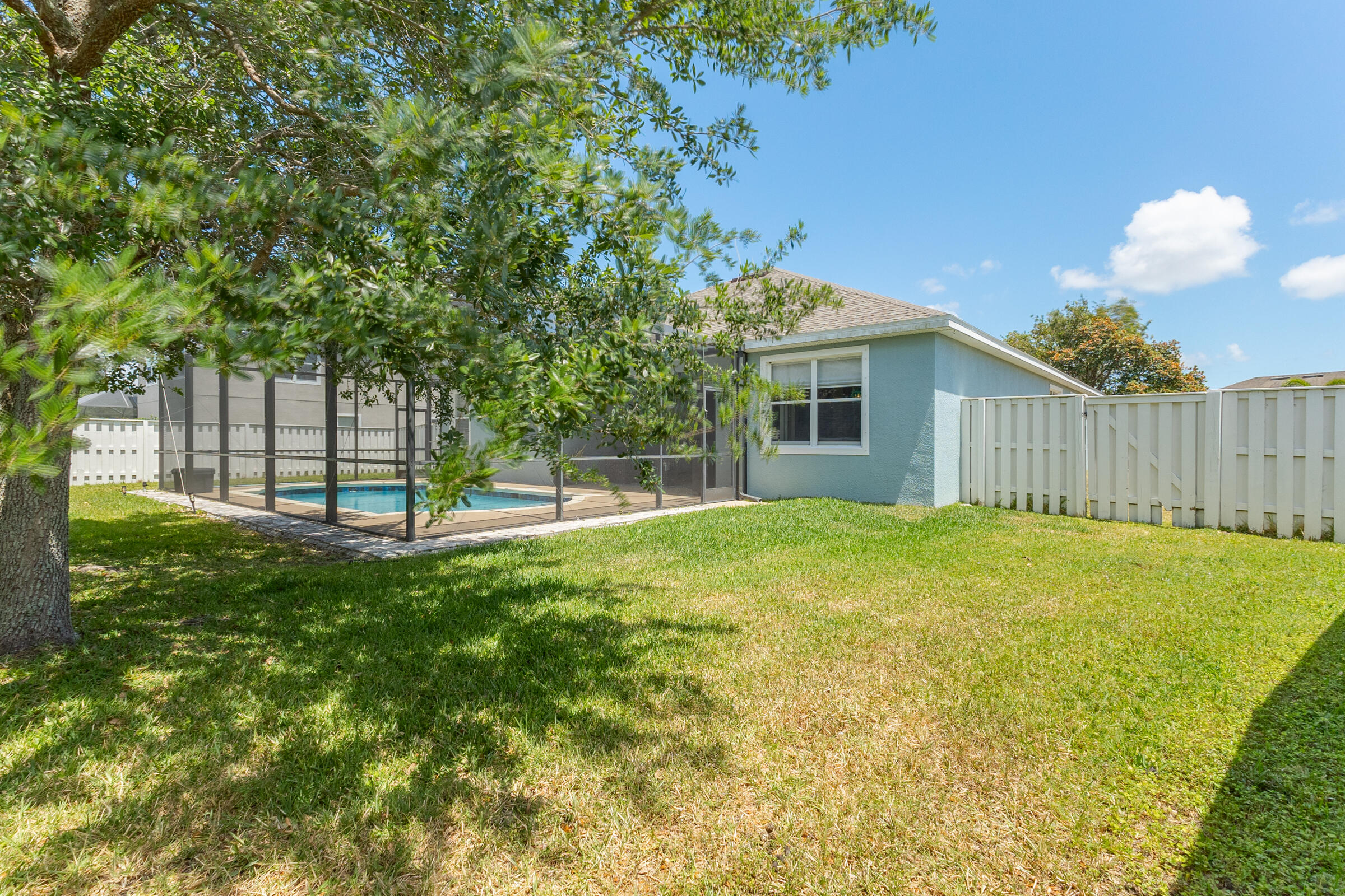 6002 Goleta Circle Melbourne, FL 32940 - Photo 27 of 45 a view of a house with a backyard and a tree