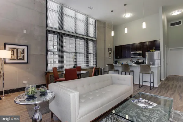 a living room with furniture a flat screen tv and a large window