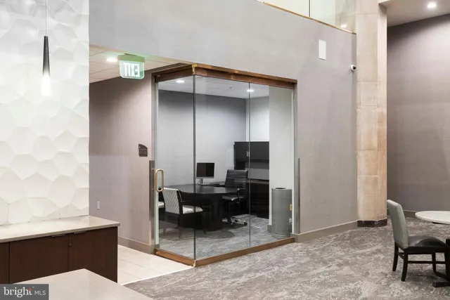 a view of a hallway with a couch and a chandelier